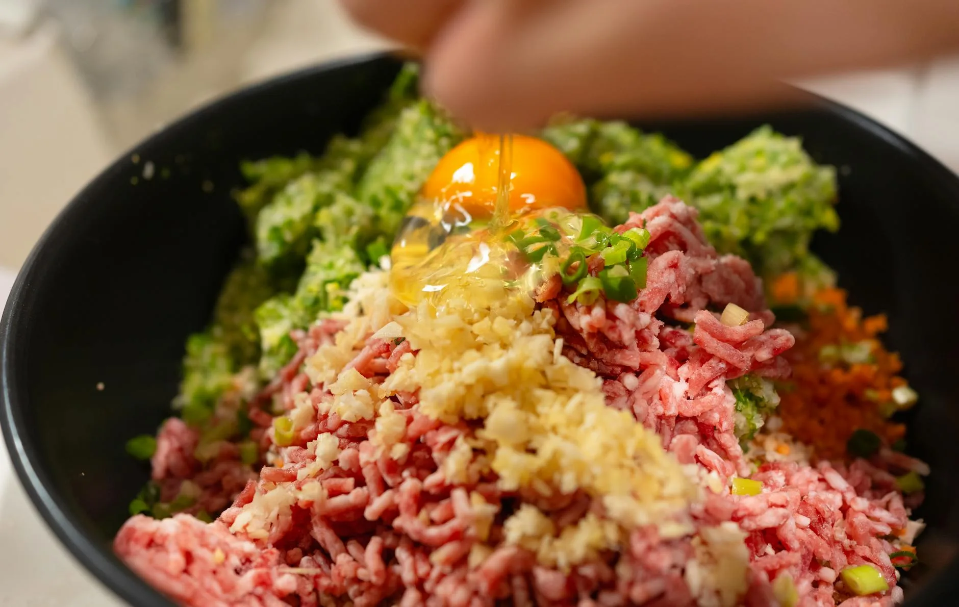 Fresh dog food with meat and vegetable ingredients in a bowl