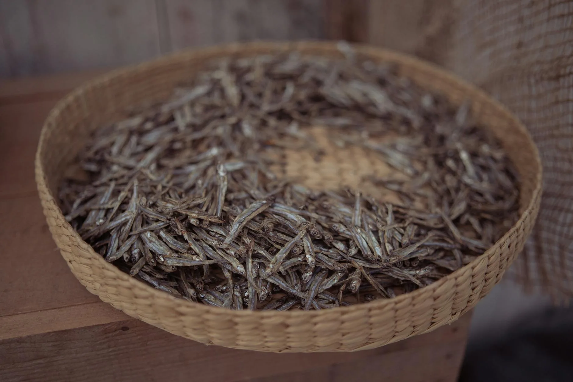 Dried fish treats for dogs spread out on a wooden surface